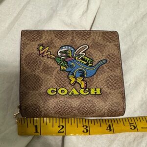 Coach Brown Signature Zip Wallet with Colorful Dino Space Graphic